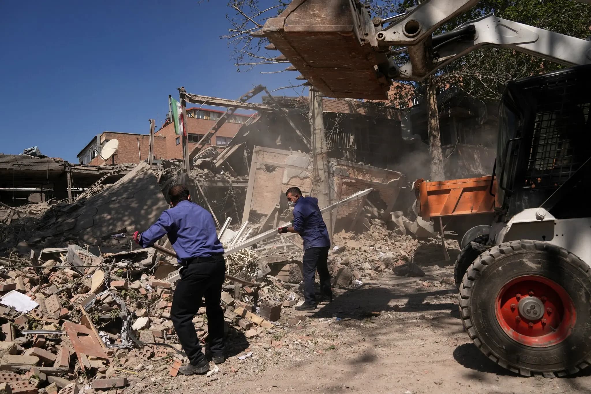 Workers clear debris on Monday at Sharif University of Technology after it was struck overnight.Credit...Francisco Seco/Associated Press
