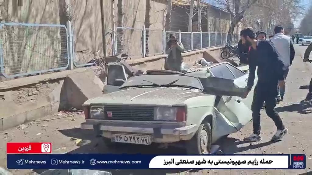 A wrecked civilian vehicle showing visible damage
