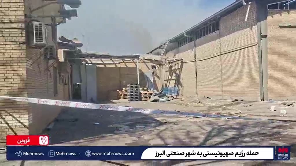 Exterior view of a damaged non-military manufacturing facility after being hit
